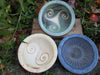 Stoneware bowls in cream, green or blue with Celtic designs in center by Ballymorris Pottery of Ireland