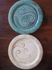 Small pottery plates in cream or green with celtic design in center made by ballymorris pottery of ireland. 